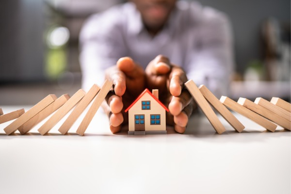 man's hands protecting model home